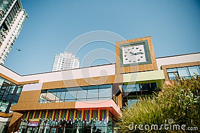 Building clock roof mirrored windows colored facade Editorial Stock Photo