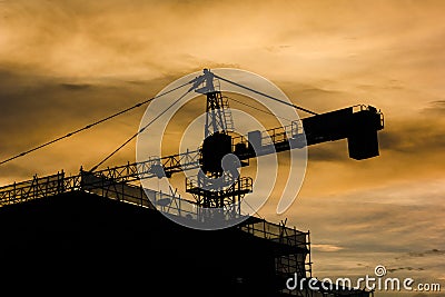 Building and Construction Crane during golden hour bright Stock Photo