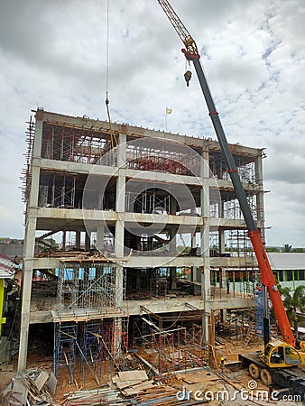 Building construction process with crane and lots of scaffolding Editorial Stock Photo