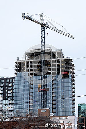 Building construction, tall skyscraper and crane against sky Editorial Stock Photo