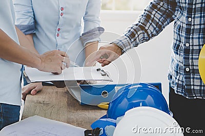 Engineer and contractor discussing material specification from client in construction site area Stock Photo