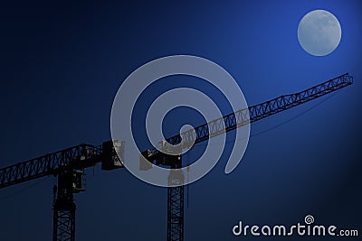 Building cranes at night Stock Photo
