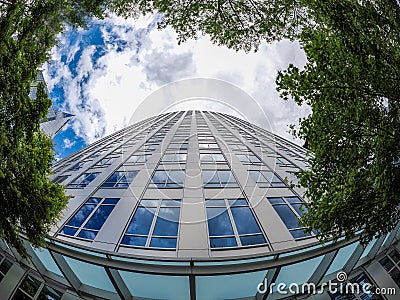 A building in downtown Bellevue in Washington, surrounded by green trees on a cloudy day Editorial Stock Photo