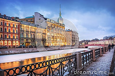 The building of the Esders and Scheufals store on the Moika embankment in St. Petersburg. Caption: At the Red Bridge Editorial Stock Photo