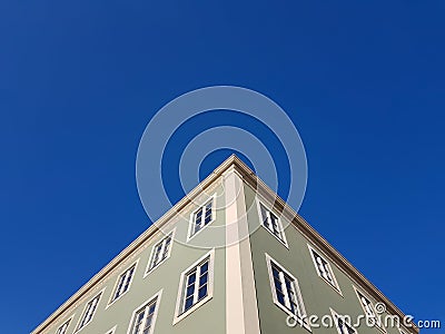 Building facade corner against blue sky Stock Photo