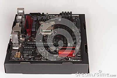 Building of gaming PC, motherboard with installing CPU. Stock Photo
