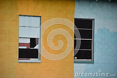 Yellow and blue paint on a concrete block building Stock Photo