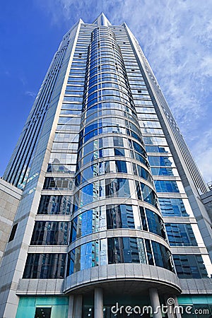 Building with glass surface and cylinder shaped front. Stock Photo