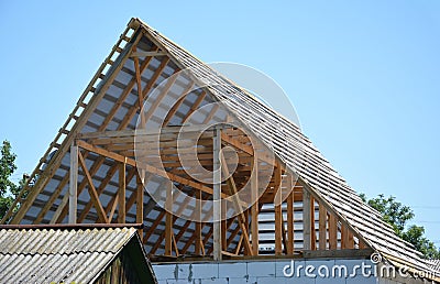 Building house attic roof construction with trusses, wooden beams, waterproofing memmbrane Stock Photo