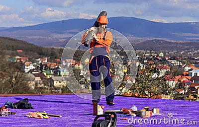 Building house. Install vapor barriers or layers of insulation on flat roofs. Roofer constructing roof. Master repair Stock Photo