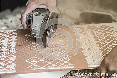 RIPPING CRAMIC. TILERS IN WORK. PAVING INSTALLER Stock Photo