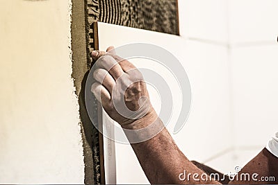 TILERS IN WORK. INSTALL AND CUT. PAVING INDOOR. Stock Photo