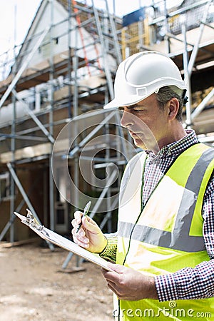 Building Inspector Looking At House Renovation Project Stock Photo