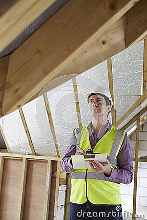 Building Inspector Looking At Roof Of New Property Stock Photo