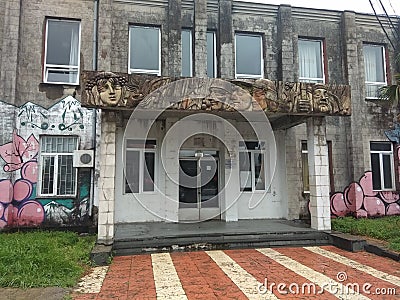 The building in Kobuleti, Georgia. A building with faces carved in stone and street art Editorial Stock Photo