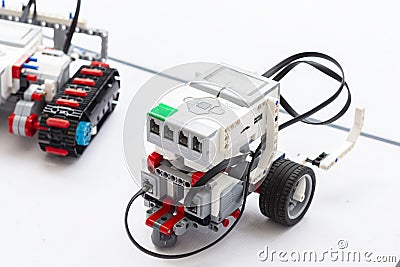 Building model RC robots concept. Radio control robot and car, RC car assembly on white work desk Stock Photo