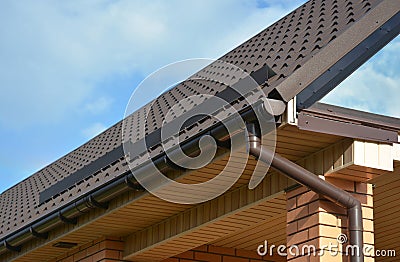 Building Modern House Construction with metal roof corner, rain gutter system and roof protection from snow Stock Photo