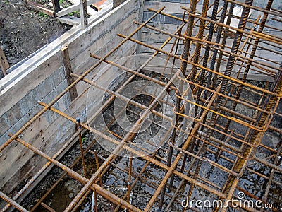 Building process, installing rebar grids for concrete foundation, detailed view. Stock Photo