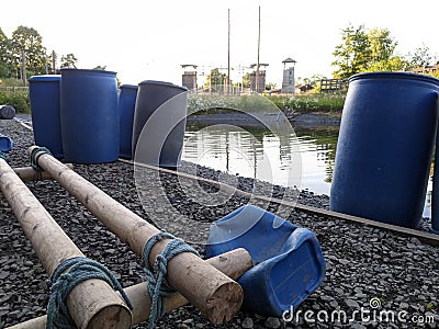 Building a raft out of blue barrels ready for the water Stock Photo