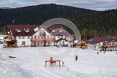 Building of the ski resort Mountain Salanga with people resting in the foothills of the Kuznetsk Alatau mountains Editorial Stock Photo