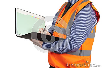 Building Surveyor in orange visibility vest writing in site folder Stock Photo