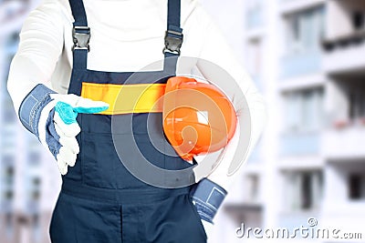 Building, teamwork, partnership, gesture and people concept - close up of builder in gloves greeting someone on construction site Stock Photo