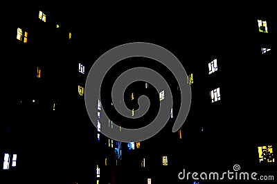 Building with a variety windows illuminated in the night sky Stock Photo