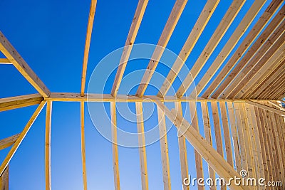 Building a wooden roof beam from a frame made out of trusses frameworks for a newly built stick home Stock Photo