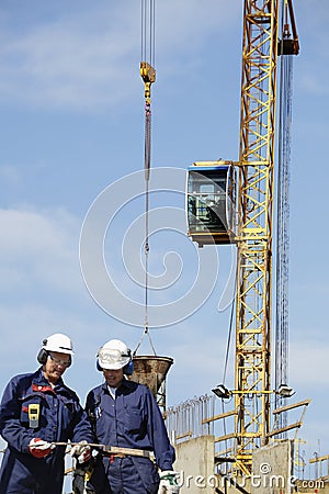 Building workers and crane in action Stock Photo