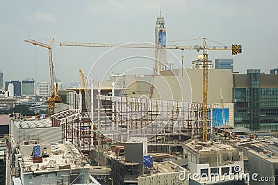 Buildings under construction and cranes under a blue sky Stock Photo