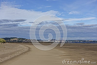 The built up area of the City of Dundee Port with Oil Rigs in for maintenance, and the small town of Tayport to the North. Stock Photo