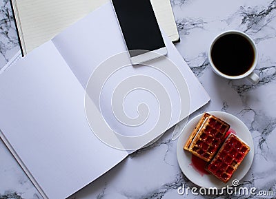 Buisness lunch with coffe anf waffles and planning the day and smartphone Stock Photo