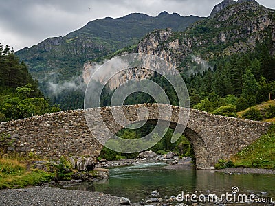 Bujaruelo ancient bridge in Pyrinees range, spain Stock Photo