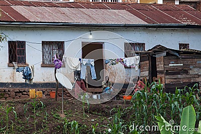 African family sitting in front of their house on the boarder of Rwanda a Editorial Stock Photo