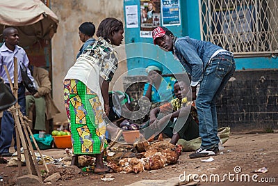 trade on the street Congolese people sitting on the ground selling chicken Editorial Stock Photo