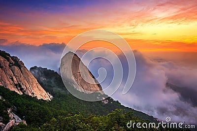 Bukhansan mountains is covered by morning fog and sunrise. Stock Photo