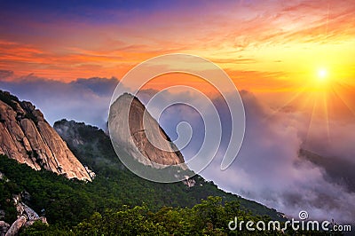 Bukhansan mountains is covered by morning fog and sunrise. Stock Photo
