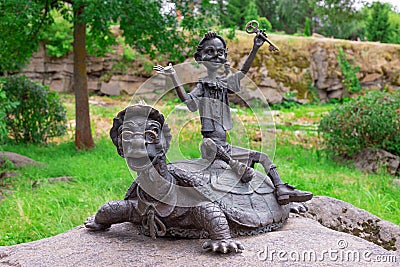 Buki or Buky, Kyiv Region, UKRAINE - June 30, 2019: Bronze Sculpture of Buratino or Pinocchio with the Golden Key and Tortilla Editorial Stock Photo