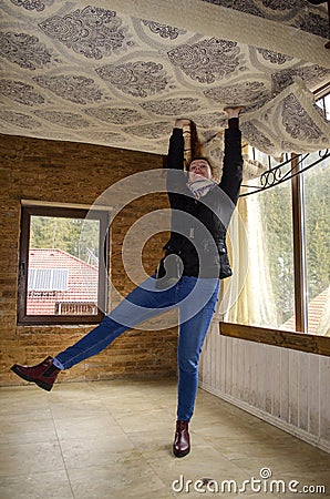 BUKOVEL, IVANO FRANKIVSKAYA OBLAST, UKRAINE- April 2, 2018: Unusual foreshortening of the girl holding the bed Editorial Stock Photo