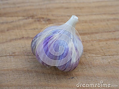 Bulb of garlic close-up on a wooden background. Agriculture Stock Photo