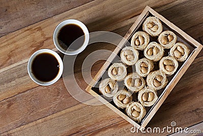 Bulbul Nest knafeh - a Middle Eastern sweet dish aysh el bolbol and Arabic coffee Qahwah with wooden background. Stock Photo