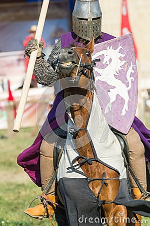 Bulgar, Russian Federation - August 2018, - a man in a knight`s suit, in a purple robe on horseback performing at the Editorial Stock Photo