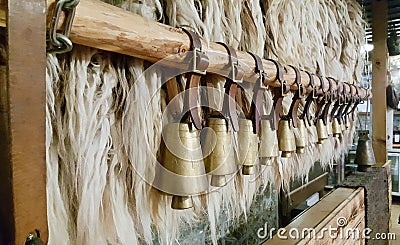 Bulgarian copper bells hanging on a wooden stick. Stock Photo