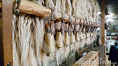 Bulgarian copper bells hanging on a wooden stick. Stock Photo