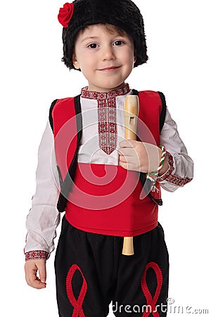 Bulgarian boy in traditional ethnic folklore costume, martenitsa and wooden flute, Bulgaria Stock Photo