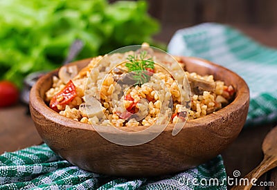 Bulgur with chicken, mushrooms and tomatoes Stock Photo