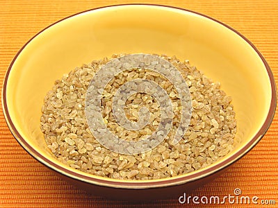 Bulgur wheat groats in a bowl of ceramic Stock Photo