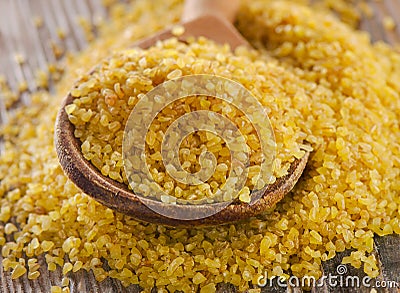 Bulgur in a wooden spoon Stock Photo