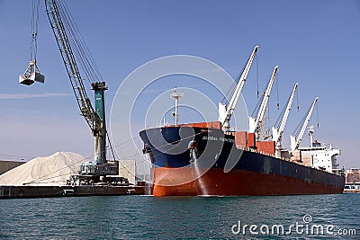 Bulk carrier Global Frontier docked and cleaning anchors. Editorial Stock Photo