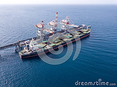 Bulk container ship unloads coal in the port of power station. Editorial Stock Photo